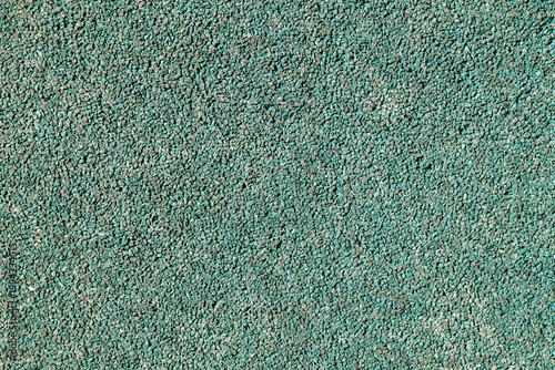 Textura de superficie de caucho granulado de color verde azulado para parques infantiles.