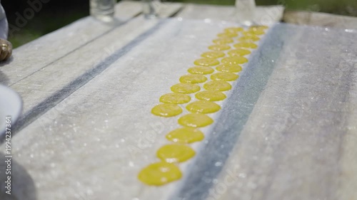 Traditional Process Of Making Dried Mango Paste In A Rural Village, a documentary video capturing villagers preparing mango paste using time honored methods and natural sunlight.