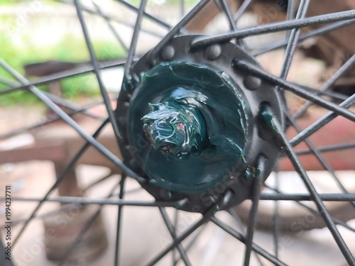 close up of bicycle bearing wheel with green grease