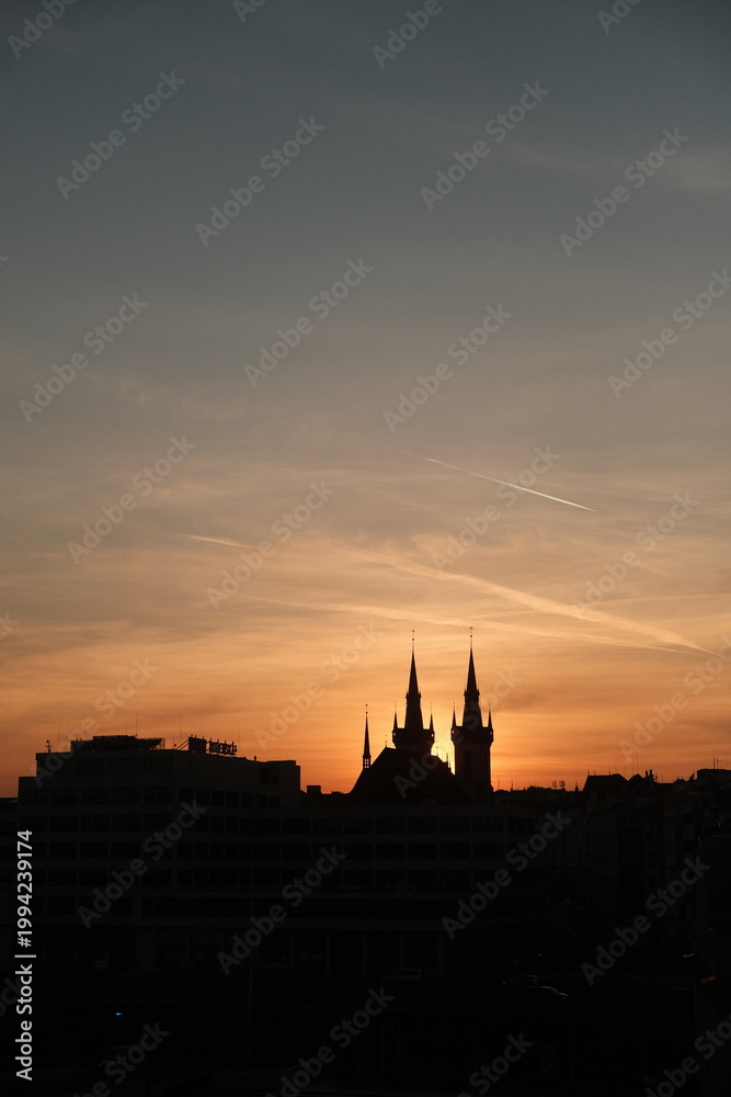 Naklejka premium Silhouetted Cityscape At Golden Sunset Hour