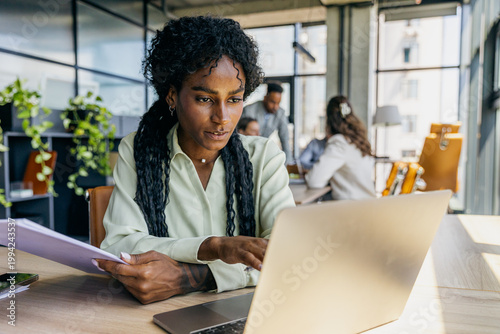 Collaborative workspace with professionals analyzing budgets diligently