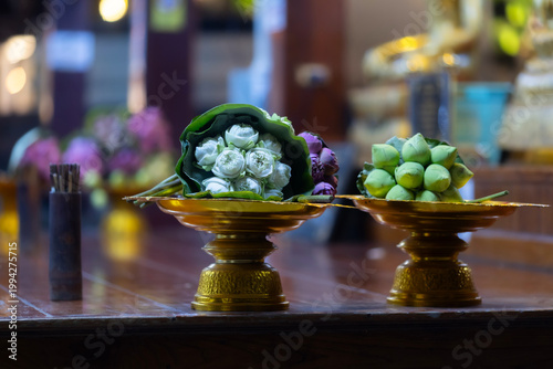 folded pink lotus flower bouquet wrapped in large green leaf resting peacefully for Buddhist to pay respect worship to Buddha at Wat Yai is a Buddhist temple is Public places in Phitsanulok,Thailand.