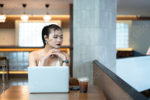 Portrait of asian freelance people businesswoman casual working with laptop computer in cafe interior in coffee shop background,business expressed confidence embolden and successful concept