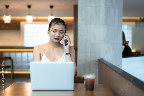 asian freelance people Beautiful business female talking making using casual working with laptop computer for browsing internet, chatting and blogging and smartphone,notebook in coffee shop.