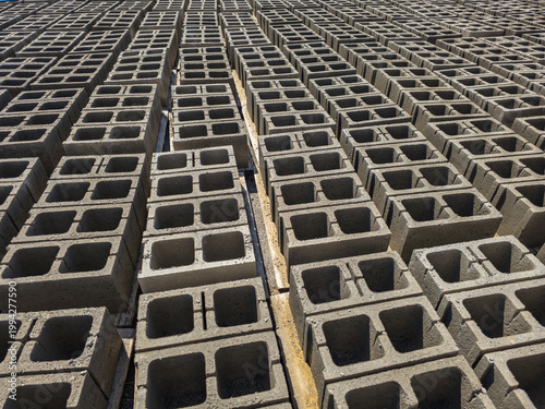 Rows of stacked concrete blocks in outdoor industrial setting