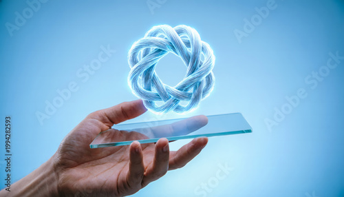 Hand holding a transparent glass tablet projecting a 3D holographic textile recycling fiber icon.