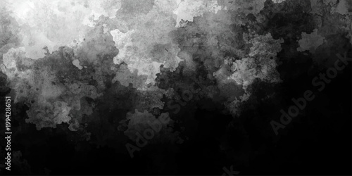 Dark stormy clouds over a city and mountain landscape blend into a black abstract sky with smoke and moon light for a dramatic nature weather background