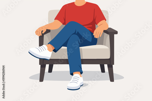 Man sitting comfortably in armchair, enjoying leisure time and casual relaxation, crossing legs in a relaxed pose