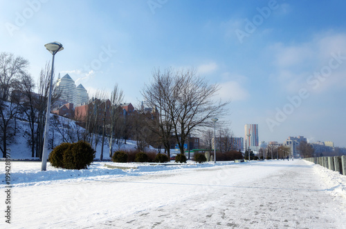 A winter day in the city. The embankment is covered with snow.