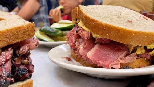 Fotografie Hearty pastrami sandwiches on rye bread with mustard and pickles, representing a