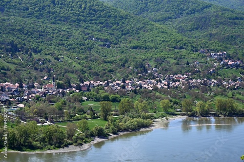 the riverbend of the Danube river at Domos village, across from Nagymaros, Hungary. lush green hills in background. popular summer holiday destination. . smooth, calm water surface. sandy beach