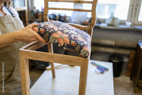 фотографія Assembling of an upholstered chair seat with fabric and filling