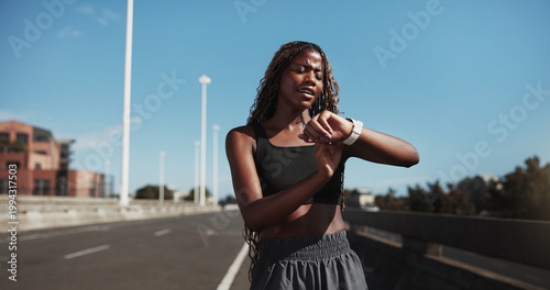 Tableau sur toile City, runner and black woman with smart watch for exercise, health app and fitness tracker in street
