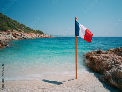 French flag flying on beautiful mediterranean beach