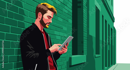 Man in black jacket with beard using tablet on green brick wall background
