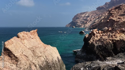 Aerial view flying over rocky coastline and turquoise sea, socotra island