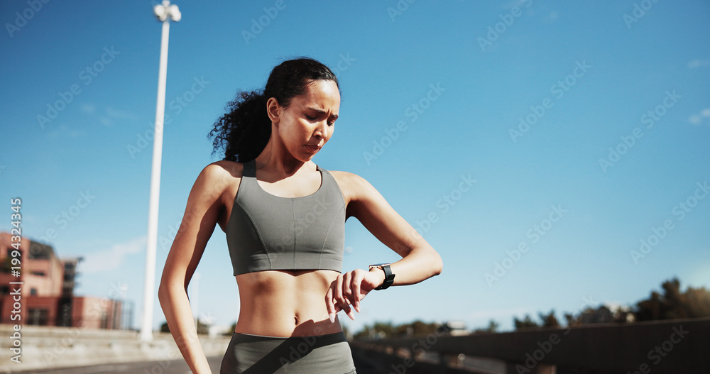 Fototapeta premium City, runner and woman with watch for exercise progress, health app and fitness tracker outdoor. Sports, blue sky and person check time for training, workout and active hobby for wellness in town