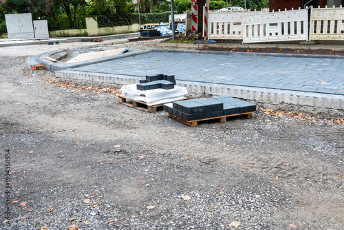 City road sidewalk repair with much pavement tiles near the house.