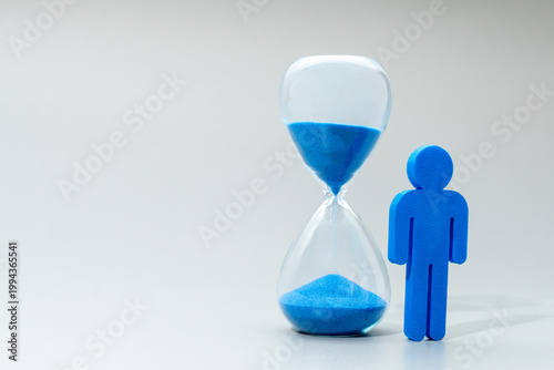 Canvas Print A blue miniature human figure and hourglass