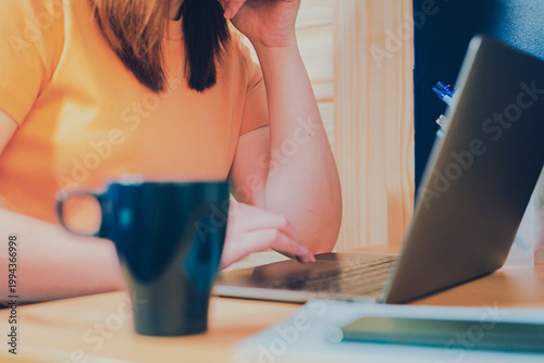 asian woman in casual wear drink coffee and work from home on her bedroom for protect corona or covid-19 virus