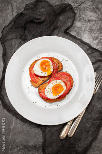 toast bread with boiled egg, tomatoes and herbs