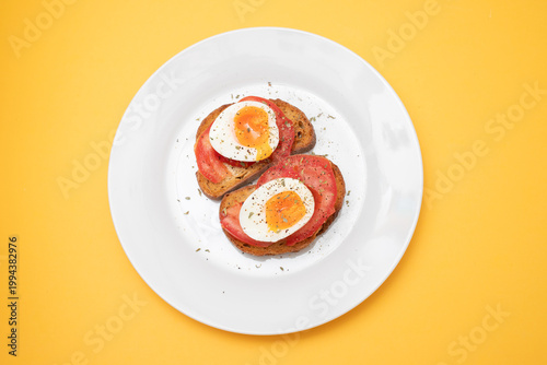 toast bread with boiled egg, tomatoes and herbs