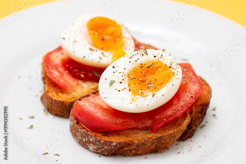 toast bread with boiled egg, tomatoes and herbs