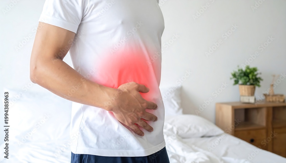 Obraz premium Man experiencing stomach pain at home.