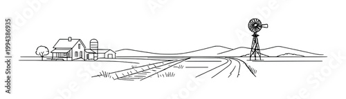 Farm buildings and windmill overlooking fields and rural hills