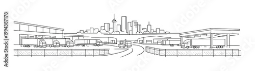 Logistics terminal with trucks and city skyline in distance