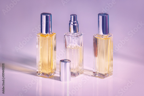 The set of elegant perfume bottles with soft pastel lighting