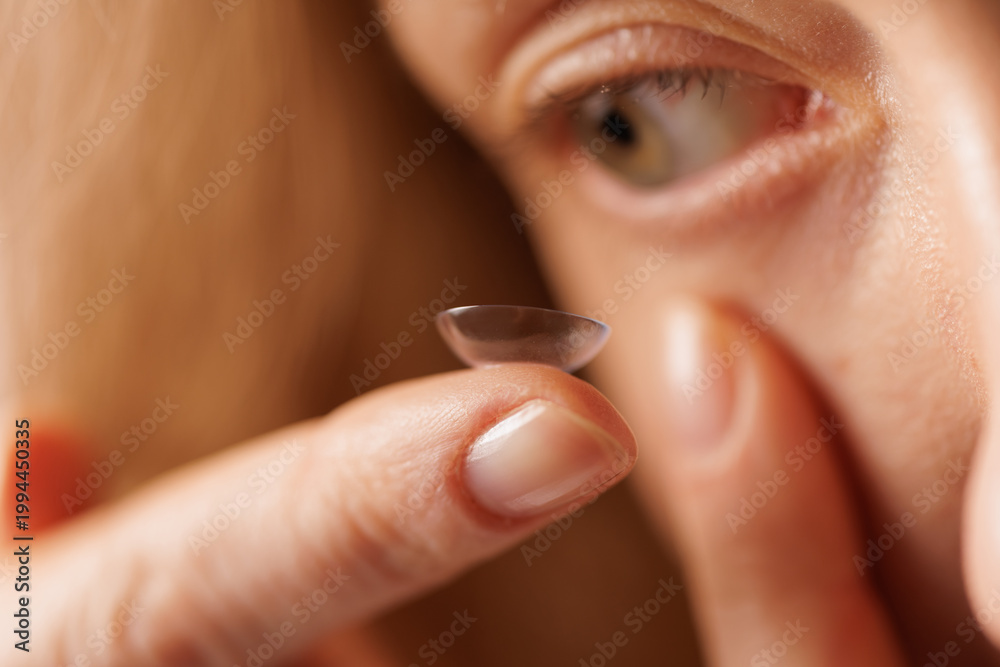 Fototapeta premium Close-up of contact lens on fingertip for vision correction and eye care routine