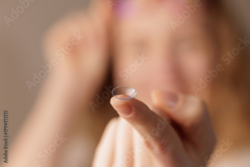 Fotografie Contact lens on fingertip close up for vision correction and eye care routine