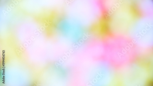 Colorful lights create a soft blur in a background setting during an evening event in a decorated space