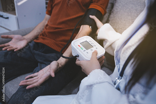 Doctor checks patient's blood pressure with cuff and stethoscope in a medical