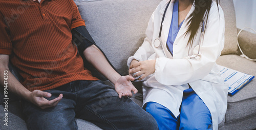 Doctor checks patient's blood pressure with cuff and stethoscope in a medical