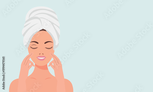 Young woman in towel doing facial massage