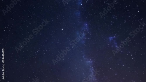 Dark night sky with stars and blue nebula clouds