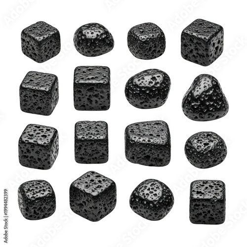 Assorted black dice arranged in a scattered pattern on a plain surface