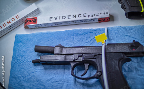 Criminalistic Laboratory, Firearm next to bullet cap for ballistic analysis, conceptual image