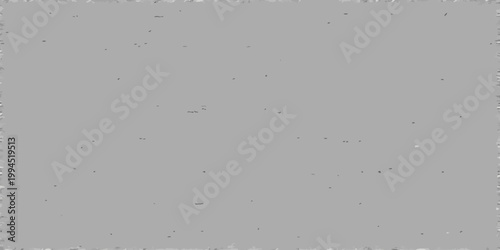 A grayscale image featuring a textured gray surface with scattered imperfections