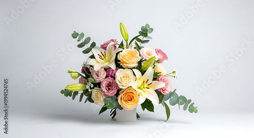 Elegant floral arrangement with lilies, roses, and eucalyptus, soft pastel colors, romantic mood, isolated on a light background, perfect for celebrations and events