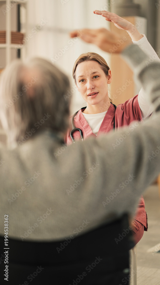 Fototapeta premium Physiotherapist assisting a senior man with exercise