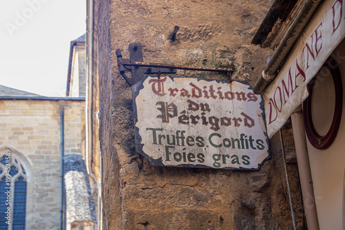 Historic shop sign listing traditional Perigord specialties in Sarlat