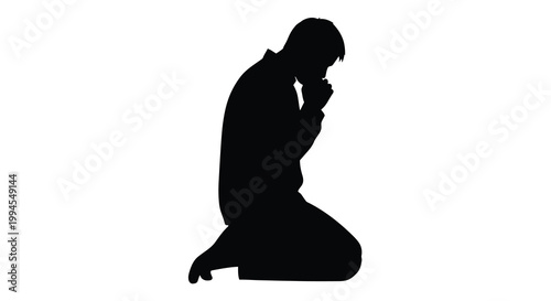 Silhouette of a person kneeling in a praying or contemplative pose