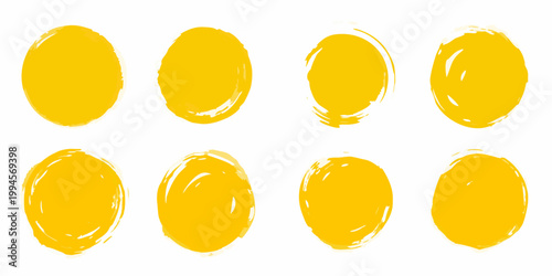 Eight vibrant yellow brushstroke shapes arranged on a plain white background
