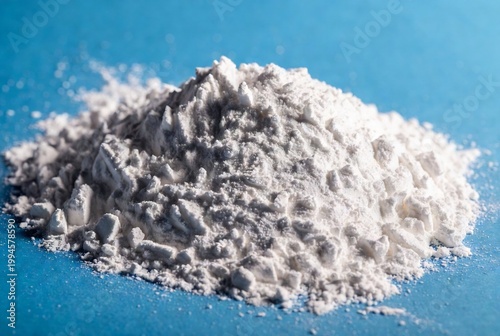 Powdered calcium carbonate, resting on a blue surface.