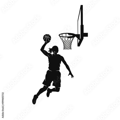 Silhouette of female basketball player dunking ball into hoop