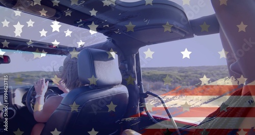 Photos Driving woman at wheel on dunes, wearing tank top, passenger's red blanket, Amer