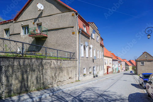 Street view of residential buildings on a sunny day with clear blue sky in a small town. Srebrna Góra, Poland